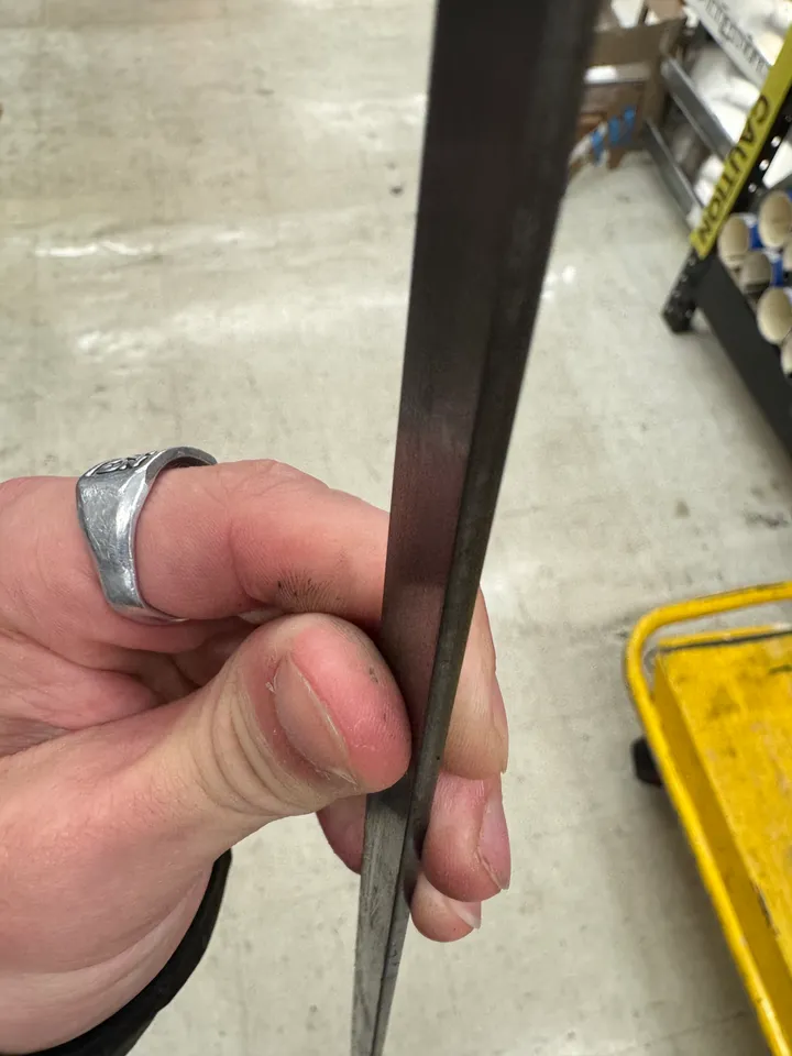 Holding a length of thin flat steel bar at the RISD store