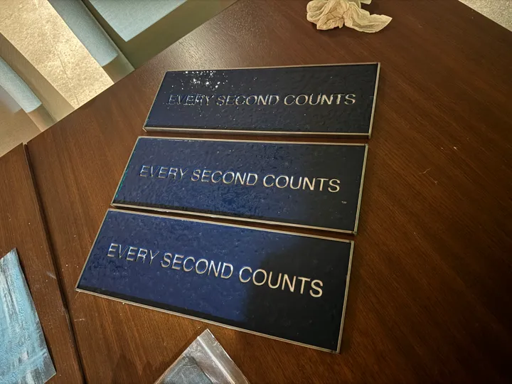 Three finished signs side by side on a table
