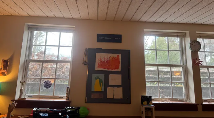 A finished sign hung between the windows of Mr. Cherry’s classroom