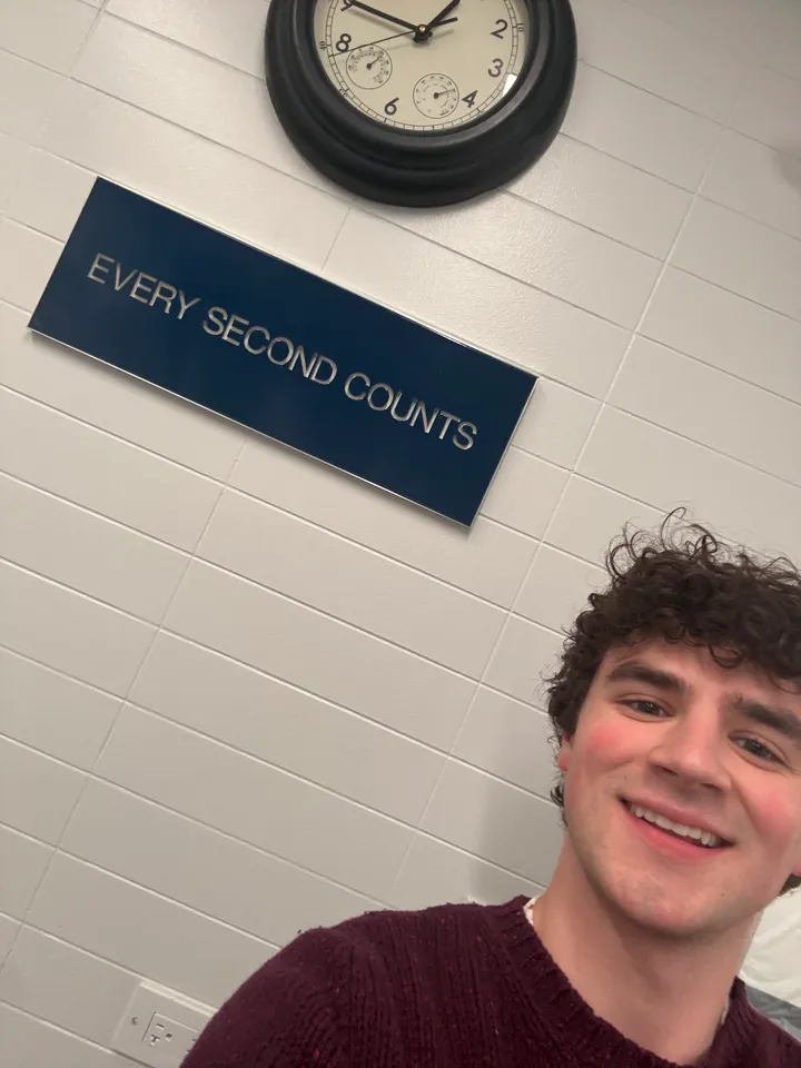 Selfie on set with the real sign, hung beneath the clock