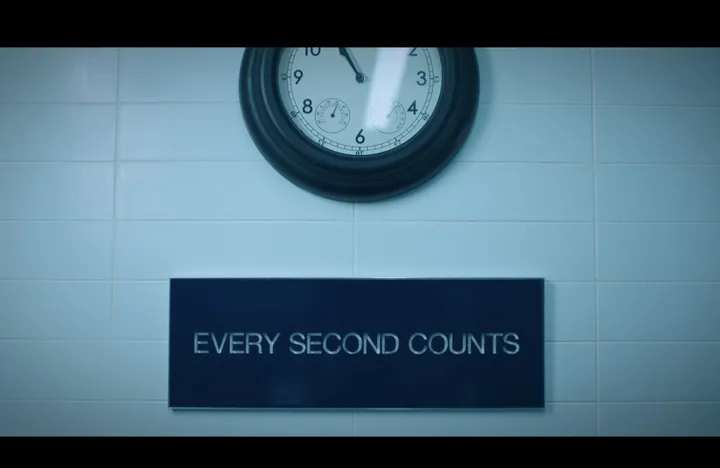 Season 2 still: the sign hung on white tiles below a round wall clock at The Bear